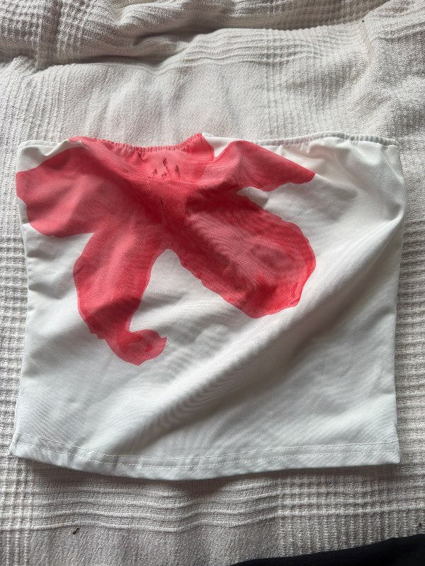 White top with pink flower